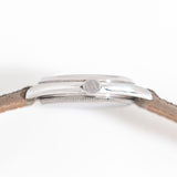 an angle of the rolex laying on its side with the crown pointed towads the viewer