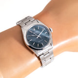 vintage rolex air king blue wrist shot, close up