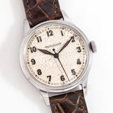 vintage jlc WWII wristwatch, on its back